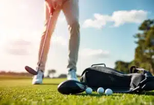 A golfer evaluating the latest golf clubs and technology on the course